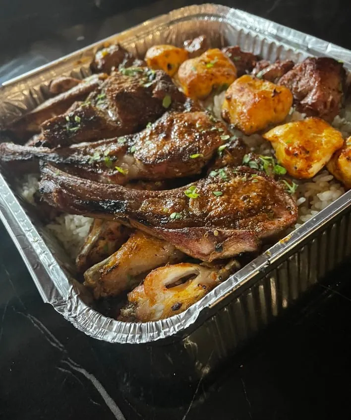 Mixed grill tray with rice and potatoes